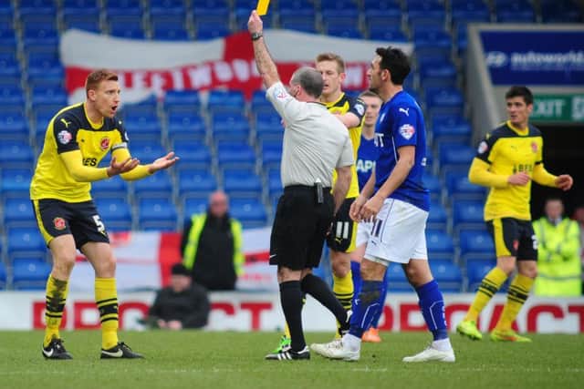 Fleetwood Town's Mark Roberts is shown a yellow card