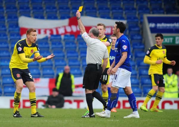 Fleetwood Town's Mark Roberts is shown a yellow card