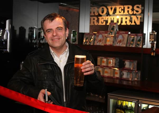 Corrie star Simon Gregson pulls the first pint at the Rovers Return set at Madame Tussauds