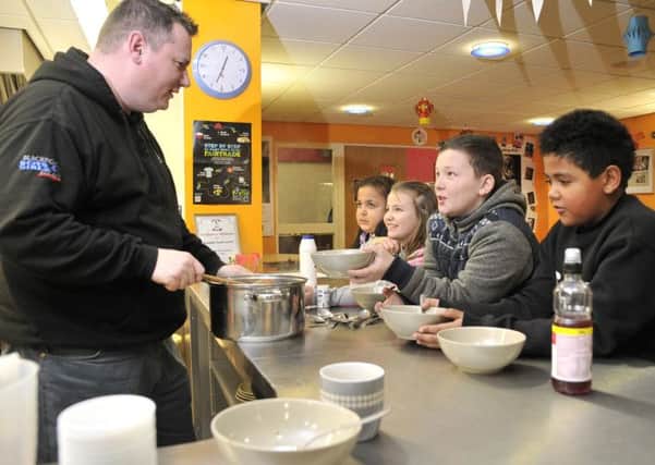 Youth worker Jed Sullivan serves lunch to, from left, Madison Smith, Emily Appleby, Tyler Masterson and Tyler Shorrocks at Blackpool Boys and Girls Club