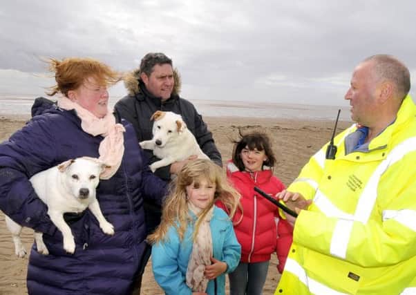 Lancashire Constabulary Community Volunteer Andrew Noble (right) signs up the Edwards family to 'In The Know' on St.Annes beach. The Edwards' are Joanne and Phil with children Skye (left) and Morgan