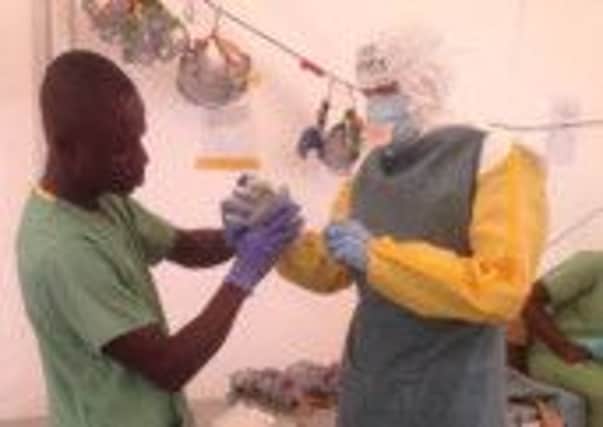 Dr James Meiring in protective clothing, spent several weeks in West Africa
