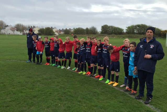 Members of Thornton Cleveleys FC Under-10s, which was set up by Craig Rigby, hold a minute's silence to pay tribute to their former manager.