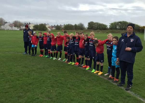 Members of Thornton Cleveleys FC Under-10s, which was set up by Craig Rigby, hold a minute's silence to pay tribute to their former manager.