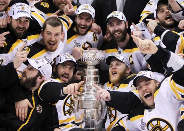 Boston Bruins players with the Stanley Cup