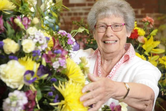 Hilda Silburn with some of the colourful displays at the flower festival held at St Thomas Church, St Annes