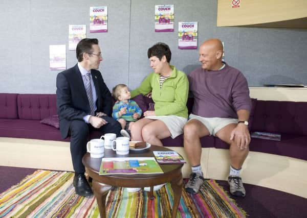 Council chief executive Neil Jack with Harry Ingle, 18mths, Gail and Lawson Atkinson on the Council Couch last year