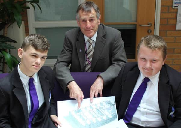 Principal Colin Simkins looks over the plans for the new Aspire Academy buildings with pupils Nathan Sarjantson and Lewis Palin
