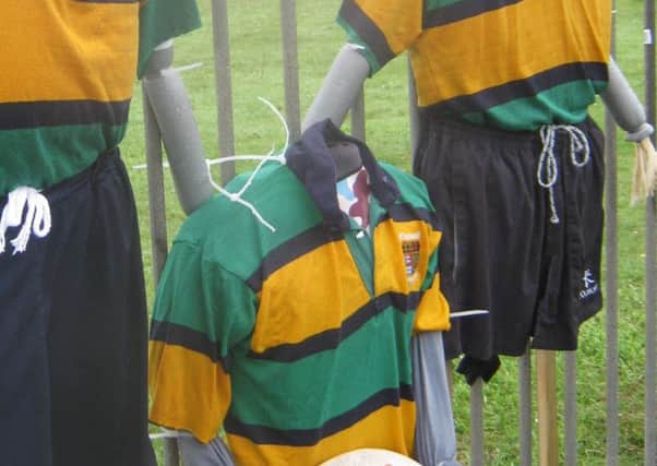 One of the rugby themed scarecrows with a missing head.