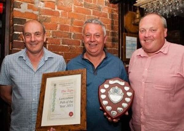 Taps landlord Steve Norris with CAMRA area organiser Adrian Smith and branch chairman Paul Smith