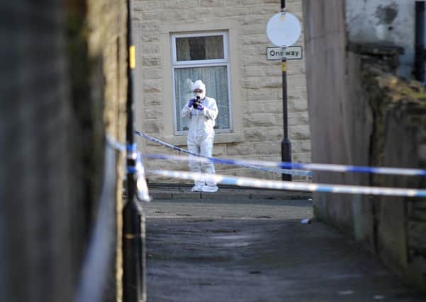 A scenes of crime officer at the shooting site in Accrington