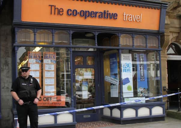 A knife-wielding robber raided the Co-op Travel store on St Annes Road West, stealing thousands of pounds