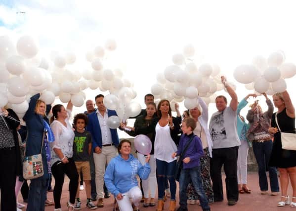 Family and friends of Blackpool man Glenn Thomas, who was killed in the MH17 air disaster, pay tribute to those who lost their lives by releasing ballons on the one-year anniversary of the tragedy. Photo: Steve McLellan