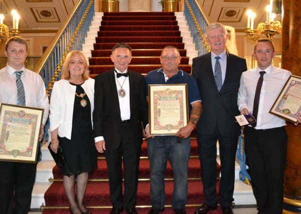 Andrew Clark (far left) Cyril Clark (centre) and Cyril Clark Jr (far right) with their certificates from Liverpool's Shipwrecked Mariners' Association.