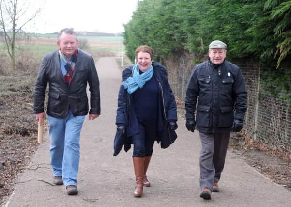 From left, Councillor James Cameron, The Mayor of Kirkham Councillor Liz Oades and Councillor Keith Beckett on the memorial path
