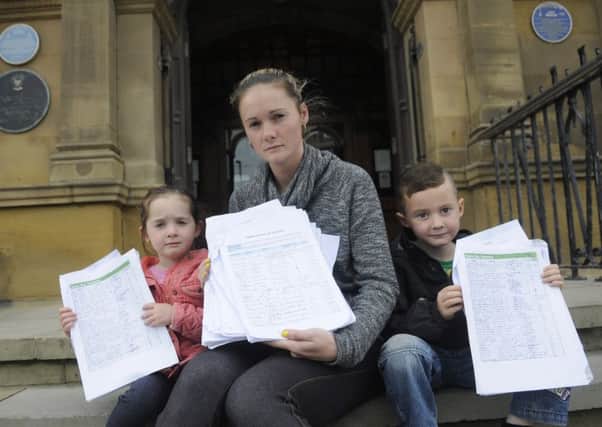Nikki Hitchon hands her petition of over 2000 signatures against proposals to close several nurseries.  She is pictured with children Ellie-Rose, aged 3 and Tyler-James, aged 5.