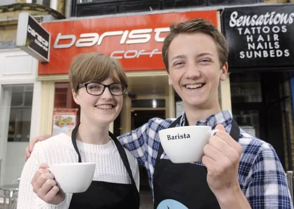 Youngsters from the National Citizen Service have set up a scheme to allow people to buy a pending coffee for the homeless at several cafes. Pictured are Brittany Morley and Luke Munday.