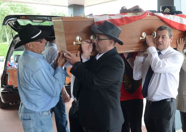 Family and friends carrying the coffin at the funeral of country and western super-fan Terry Hunt