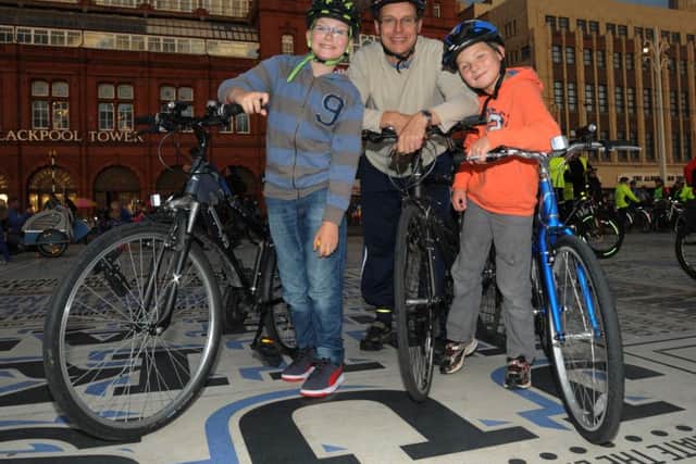 BLACKPOOL - BEG
Justin Dee, centre, with sons William, 12, left, and Edward, nine, right.
Families and friends get on their bikes for the annual Ride the Lights event, cyclists could ride up and down the Promenade, a bike-only-zone for one night only, from 6pm until 10pm.