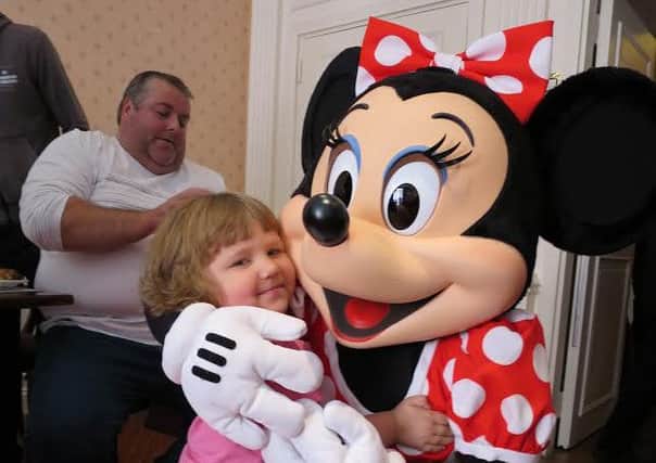 Joy: Four-year-old Jessica and her family enjoying their time in Disneyland, Paris