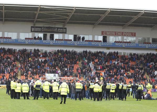 Blackpool fans stage a protest and pitch invasion against the running of the club by owner Owen Oyston