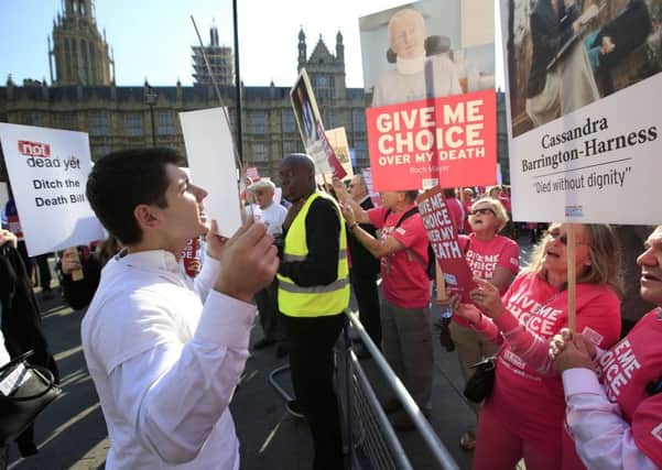 Protesters opposed to assisted dying outside Parliament yesterday