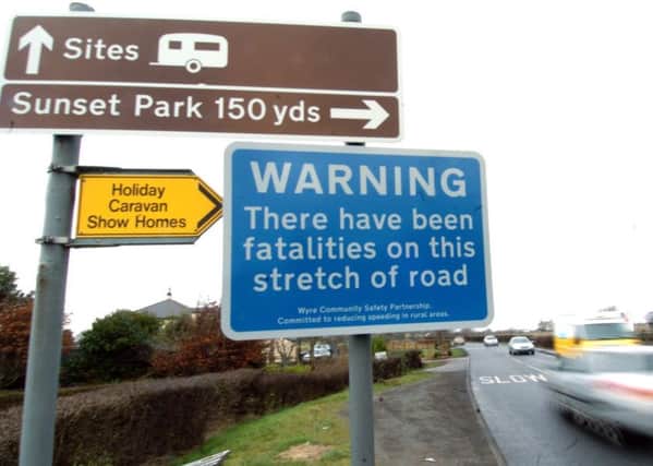 Signs warning motorists the A588 is a deadly road have been put up, but parish councillor June Jackson wants average speed cameras installed