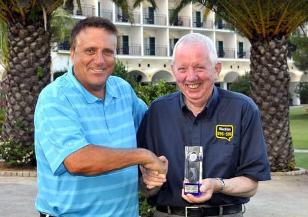 Ian Wharmby (left) from sponsors Blacktax, presents the 2014 Gazette-Blacktax Matchplay Golf Tournament trophy to Maurice Cashman, at the Penina Sir Henry Cotton Championship Course in the Algarve.