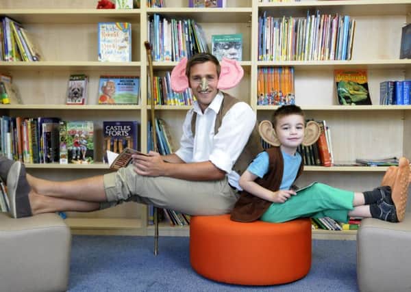 Children and teachers from Royles Brook Primary School dress up as Roald Dahl characters and mark the opening of their new library.  Teacher Chris Morris with Logan Martin-Skimming.