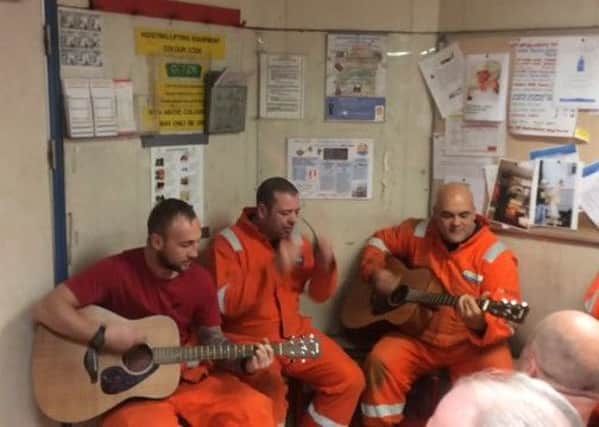 Daniel Markbride, right, performs Oasis song Talk Tonight with his fellow oil rig workers