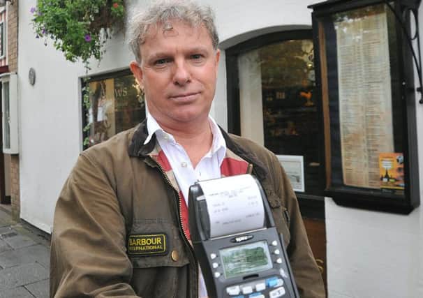 The Mews Thai restaurant in Poulton has been left without a functioning card machine for almost two weeks, affecting business  and with no explanation from the card machine company.
Mews owner Lindon Sedman with the machine.  PIC BY ROB LOCK
28-10-2015