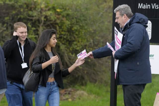 Blackpool and the Fylde College staff protest outside in row over pay.  Pictured is Eddie Collett handing out leaflets to students.