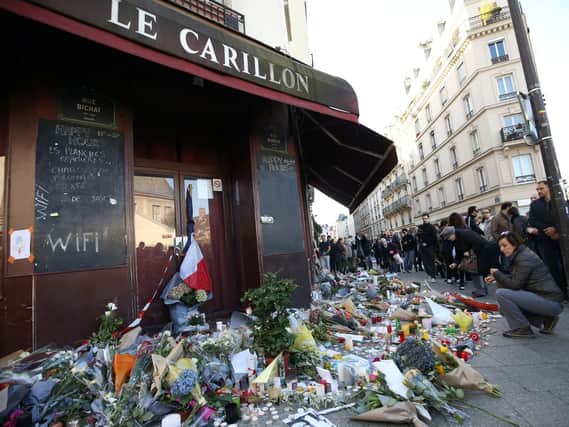 Tributes are left at the La Carillon restaurant in Paris, following the attacks in the French capital which are feared to have killed around 129 people.