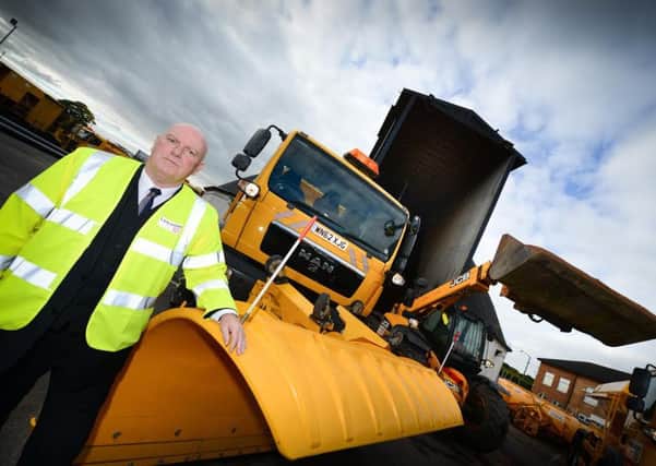 County Councillor John Fillis, cabinet member for highways and transport, with staff responsible for managing the county's gritting operation