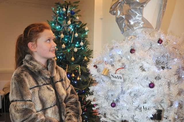 The Christmas Tree Festival opened in Blackpool Winter Gardens' Derham Lounge.10 year-old Millie Greenhalgh admires a wedding dress-styled tree.