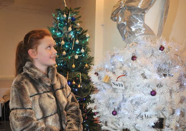 The Christmas Tree Festival opened in Blackpool Winter Gardens' Derham Lounge.
10 year-old Millie Greenhalgh admires a wedding dress-styled tree.