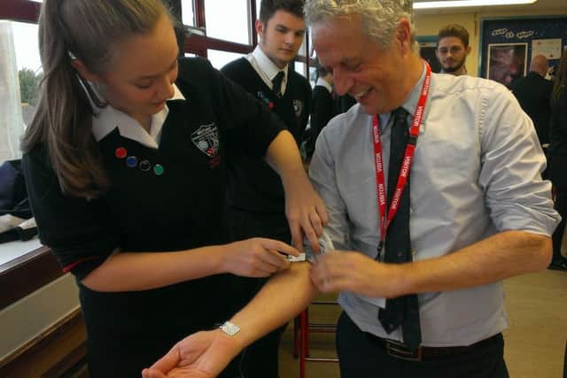 Cuadrilla CEO Francis Egan gets his pulse taken by student Lucy Aliison