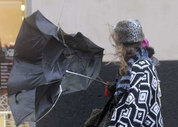 Brollies get blown inside out as shoppers battle the elements at the Houndshill Centre yesterday