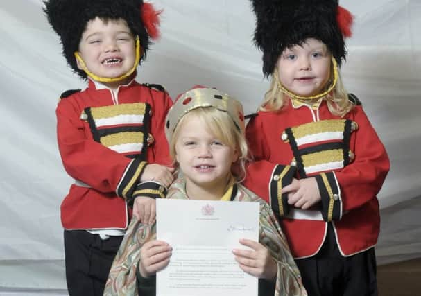 Children from Treetops Nursery have received a letter from the Queen.  Georgia Andrews with guards Sebastian Smith and Anna-Rose Townsend.