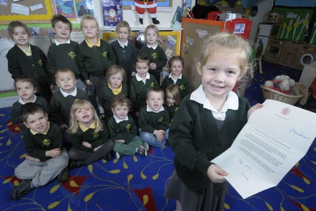 Children from Treetops Nursery have received a letter from the Queen.  Holly Wallis, 3, holds the letter in front of her friends.