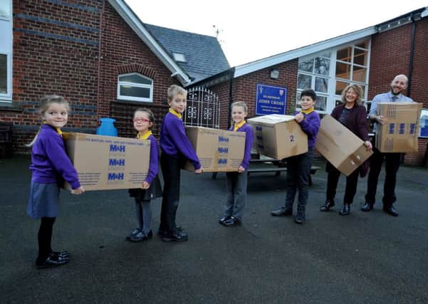 CHARITY: Pupils at Bilsborrow John Cross school with boxes of warm clothes for refugees