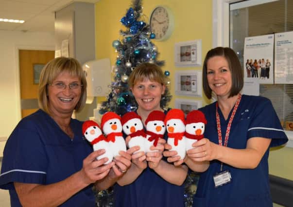Advanced neonatal nurse practitioner, Liz Morrison, with neonatal unit sisters Sarah Heydon, and Amy Gregory, with knitted snowmen