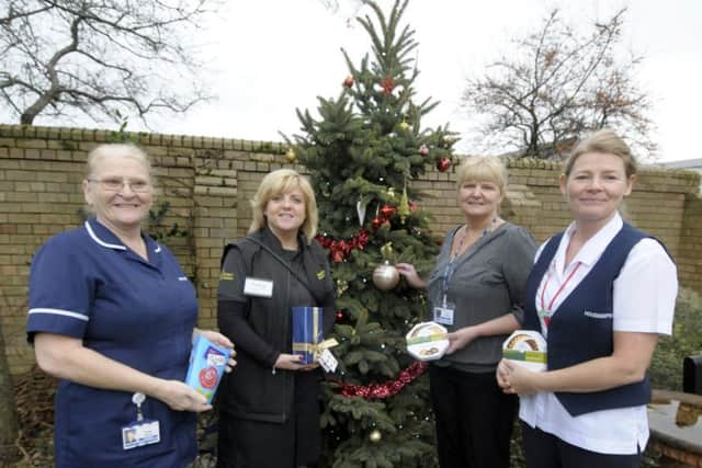 Members of Just Good Friends and fire cadets deliver Christmas presents to patients at Clifton Hospital.  L-R are Pauline Bishop, Tracy Gray, Dawn Johnson and Samantha Barclay