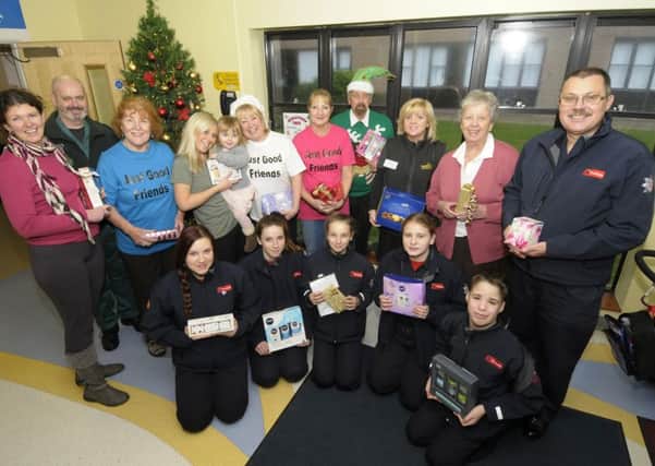 Members of Just Good Friends and fire cadets deliver Christmas presents to patients at Clifton Hospital