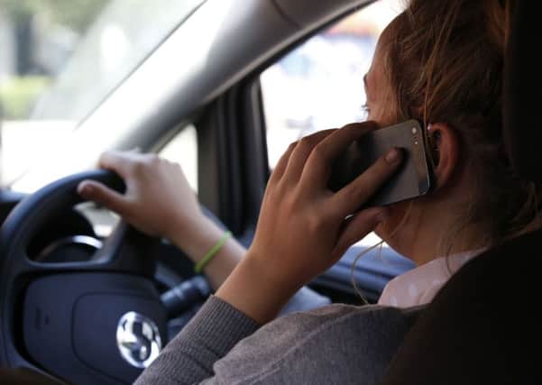 CARELESS TALK: Drivers caught using mobile phones at the wheel face stiffer penalties - and insurance premiums