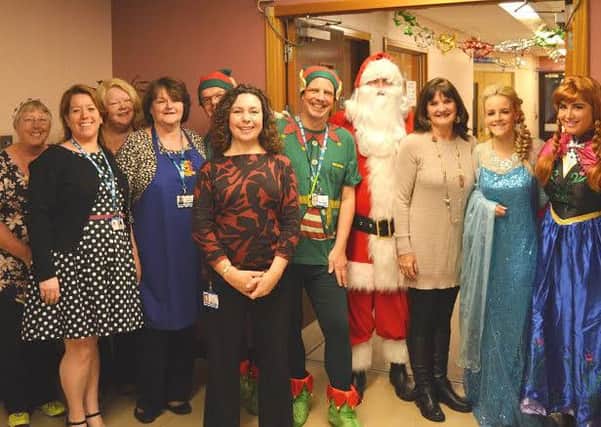Clifton Hospital staff and visitors, including Anne Nolan (third right), Father Christmas and fairy-tale princesses Anna and Elsa at Clifton Hospital
