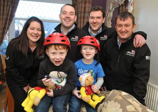 Sebastian and Jacob Holmes were rescued by RNLI Flood Rescue Team members in Cumbria, and received special helmets from the team