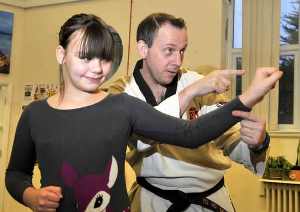 Erica Smith-Wilkinson (11) has her first lesson with Tae Kwon Do Instructor Ben Constable