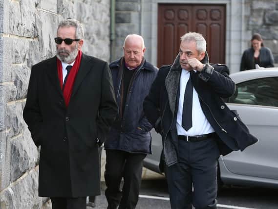 Sam Torrance, in the glasses and Paul McGinley (right) among the mourners