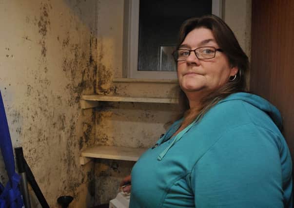 Disabled tenant Sarah Shaw, of Rede Avenue in Fleetwood, alleges her housing association has dismissed her claim that the property is suffering from a damp problem.
Sarah with damp in a storage room.  PIC BY ROB LOCK
8-1-2016